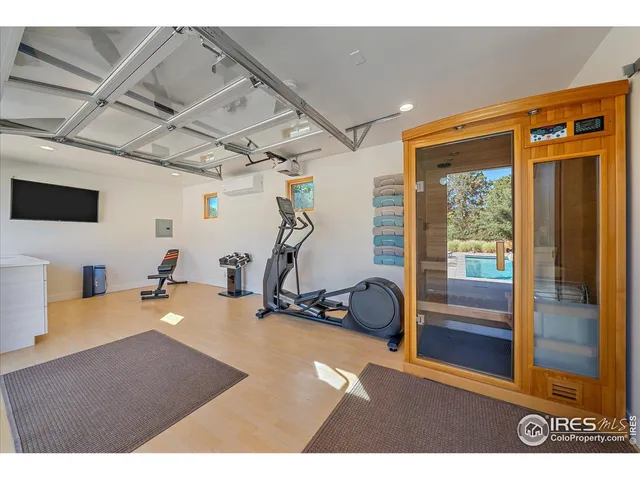 a room with gym equipment and view of living room