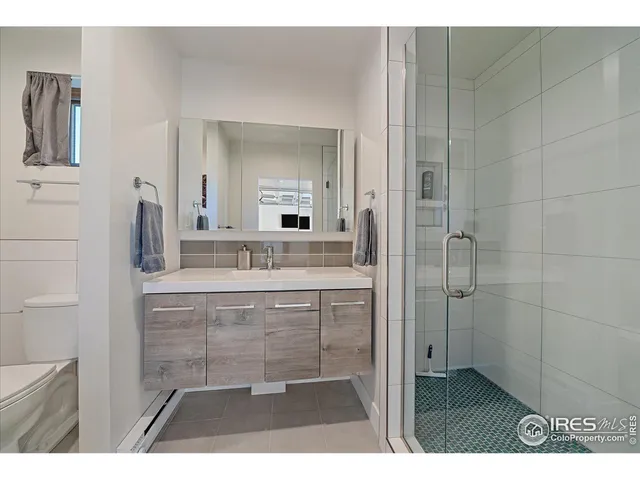 a bathroom with a sink a mirror and a shower