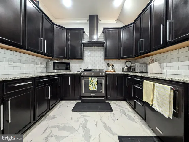 a kitchen with wooden cabinets and stainless steel appliances