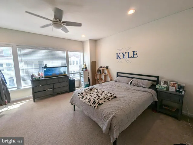 a spacious bedroom with a bed and a chandelier