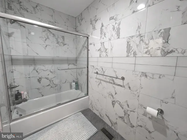 a bathroom with a bathtub and shower