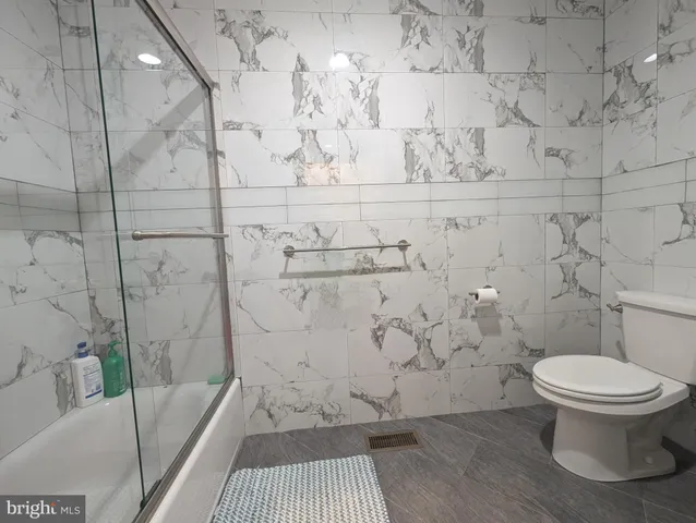 a bathroom with a toilet and a shower
