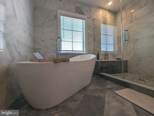 a bath tub sitting in a bathroom next to a window