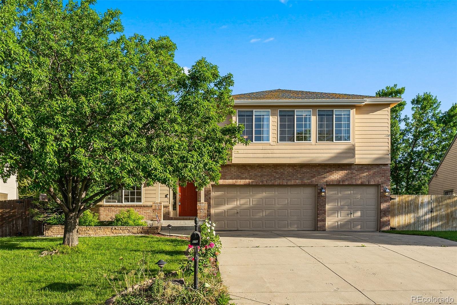 276 East Fair Lane Centennial, CO 80121 - Photo 1 of 38 a front view of a house with a yard