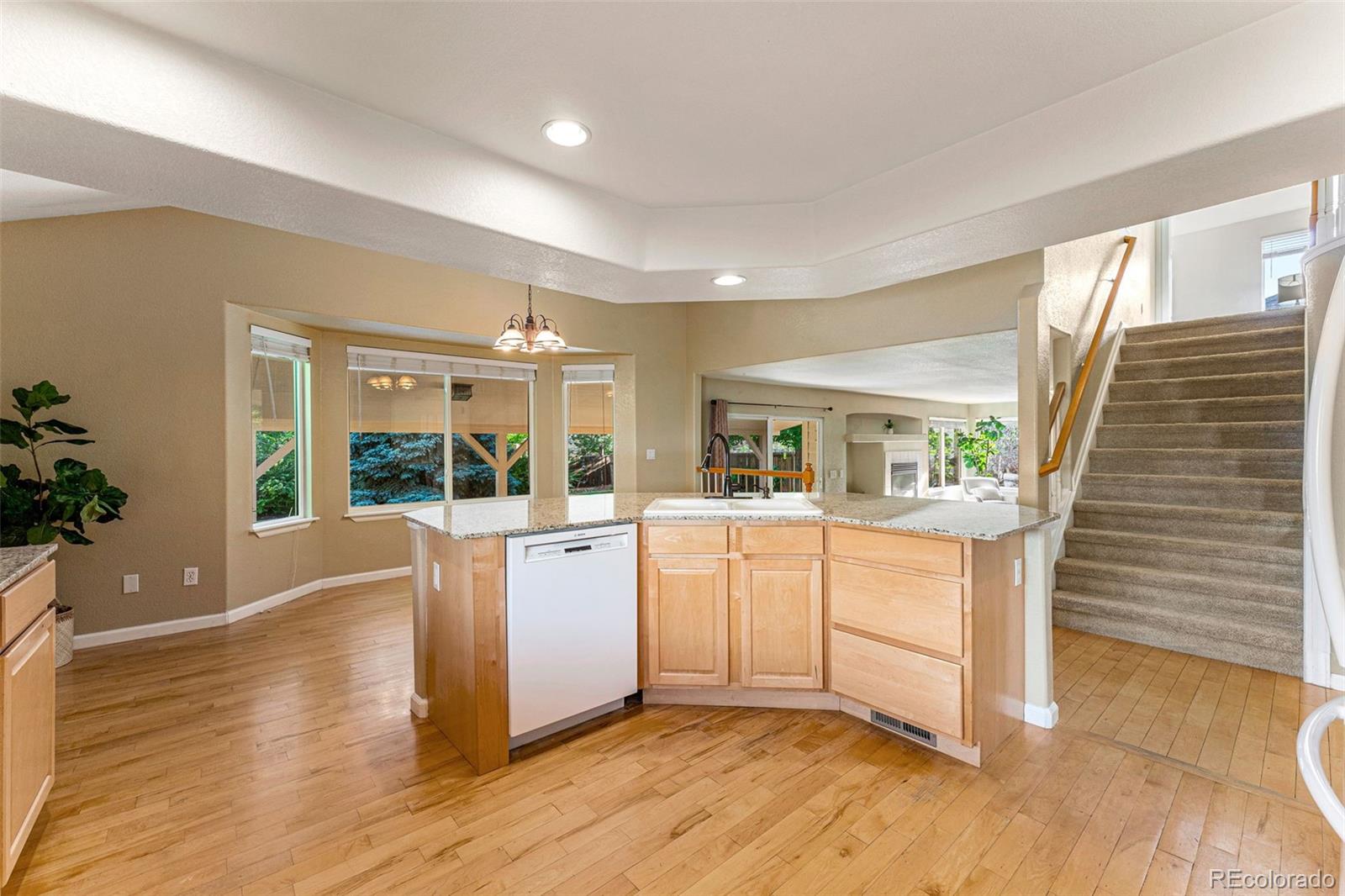 276 East Fair Lane Centennial, CO 80121 - Photo 12 of 38 a kitchen with cabinets and wooden floor