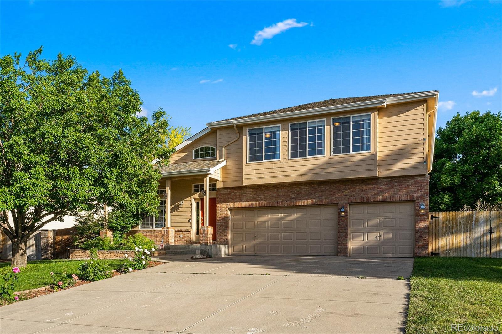 276 East Fair Lane Centennial, CO 80121 - Photo 2 of 38 a front view of a house with a yard