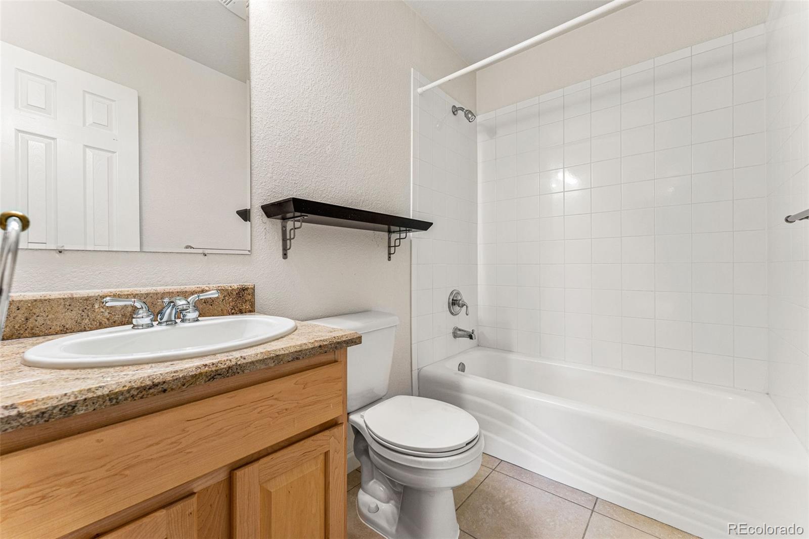 276 East Fair Lane Centennial, CO 80121 - Photo 28 of 38 a bathroom with a sink a toilet and a bathtub