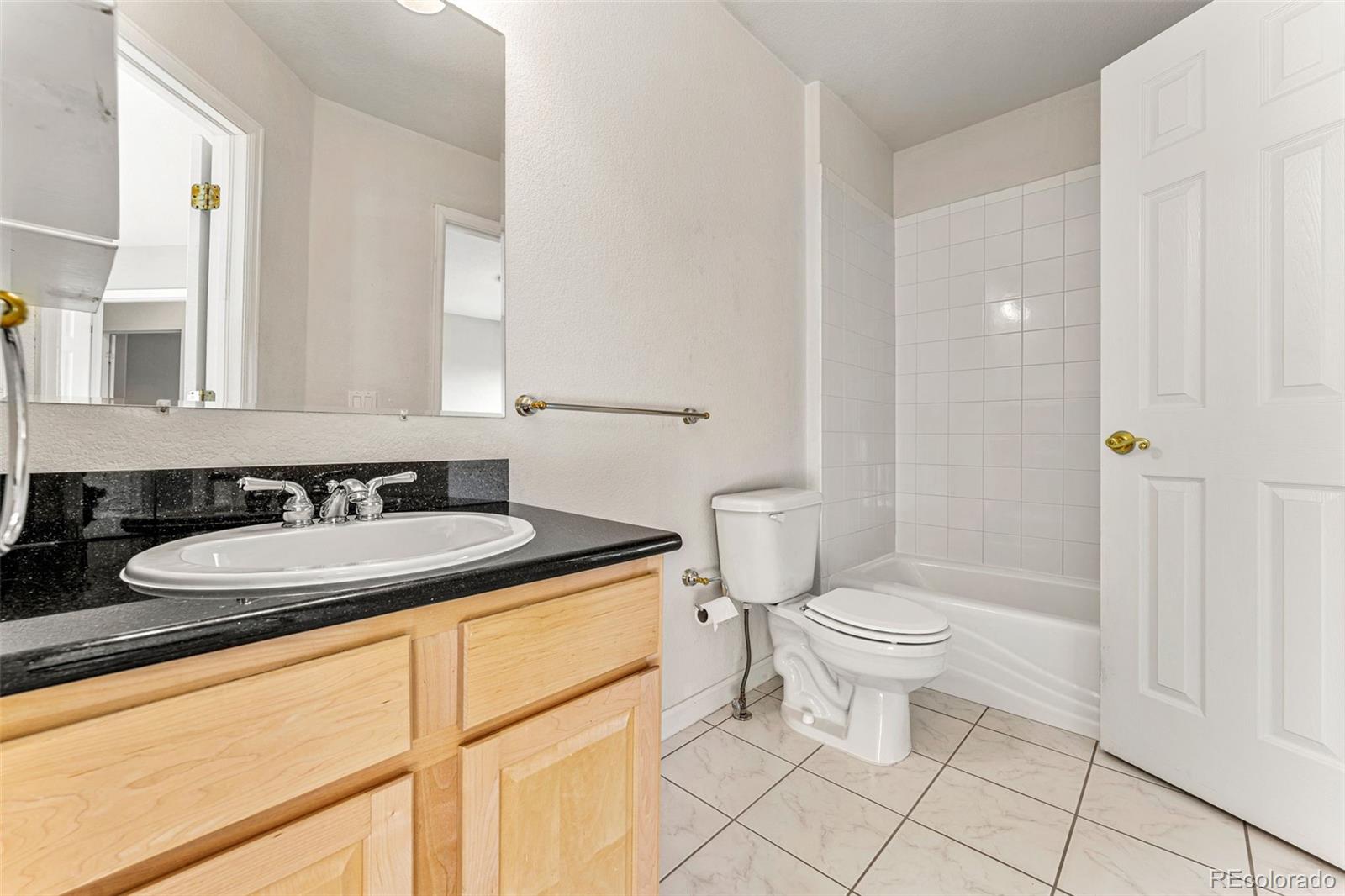 276 East Fair Lane Centennial, CO 80121 - Photo 31 of 38 a bathroom with a sink a toilet and shower