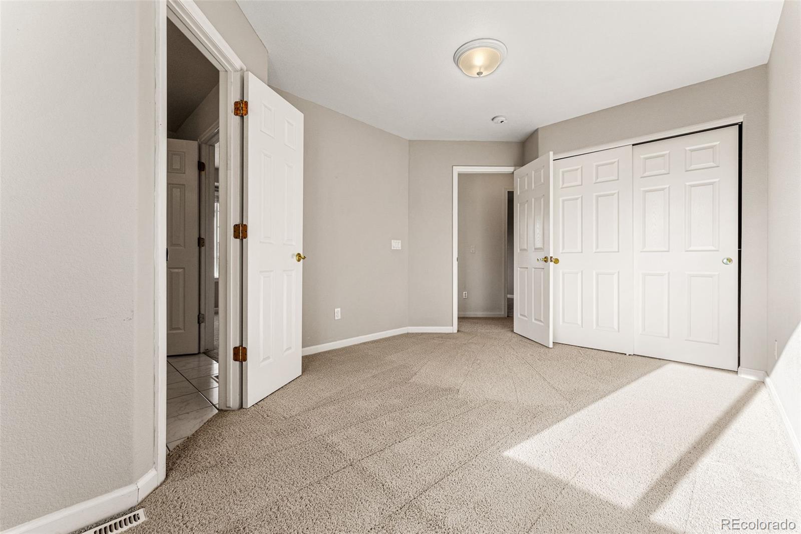 276 East Fair Lane Centennial, CO 80121 - Photo 33 of 38 an empty room with closet and a hallway