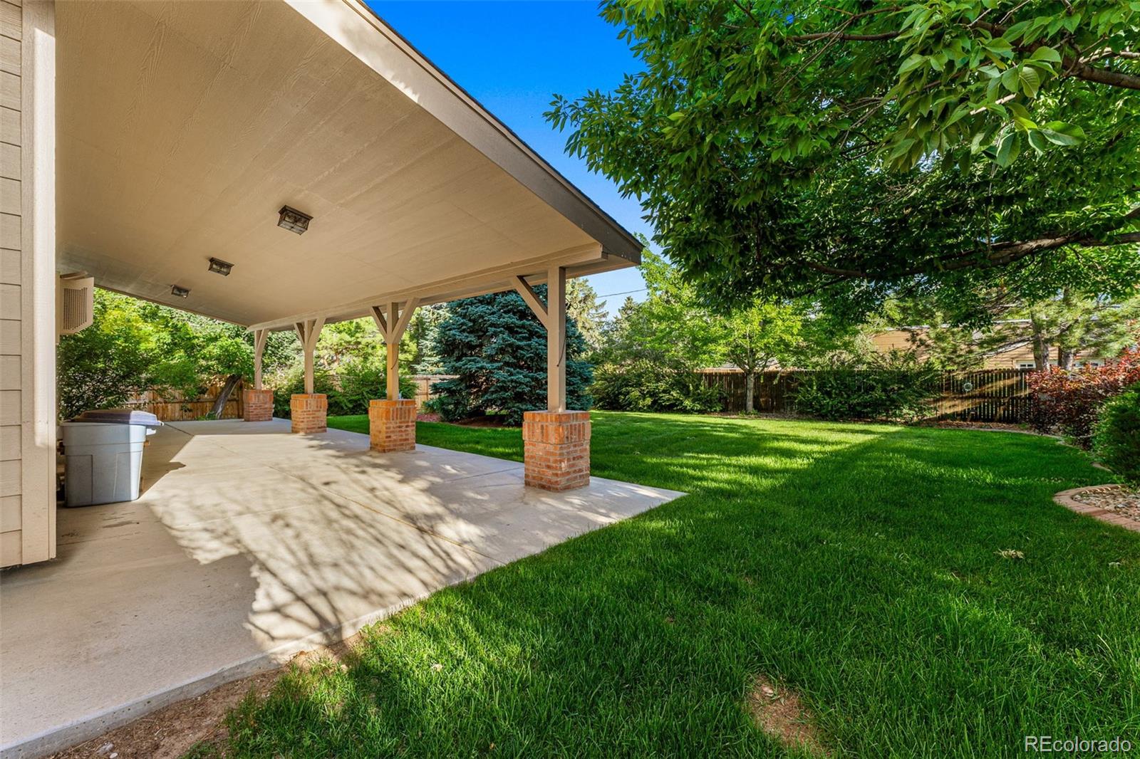 276 East Fair Lane Centennial, CO 80121 - Photo 35 of 38 a view of a patio with a table and chairs under an umbrella