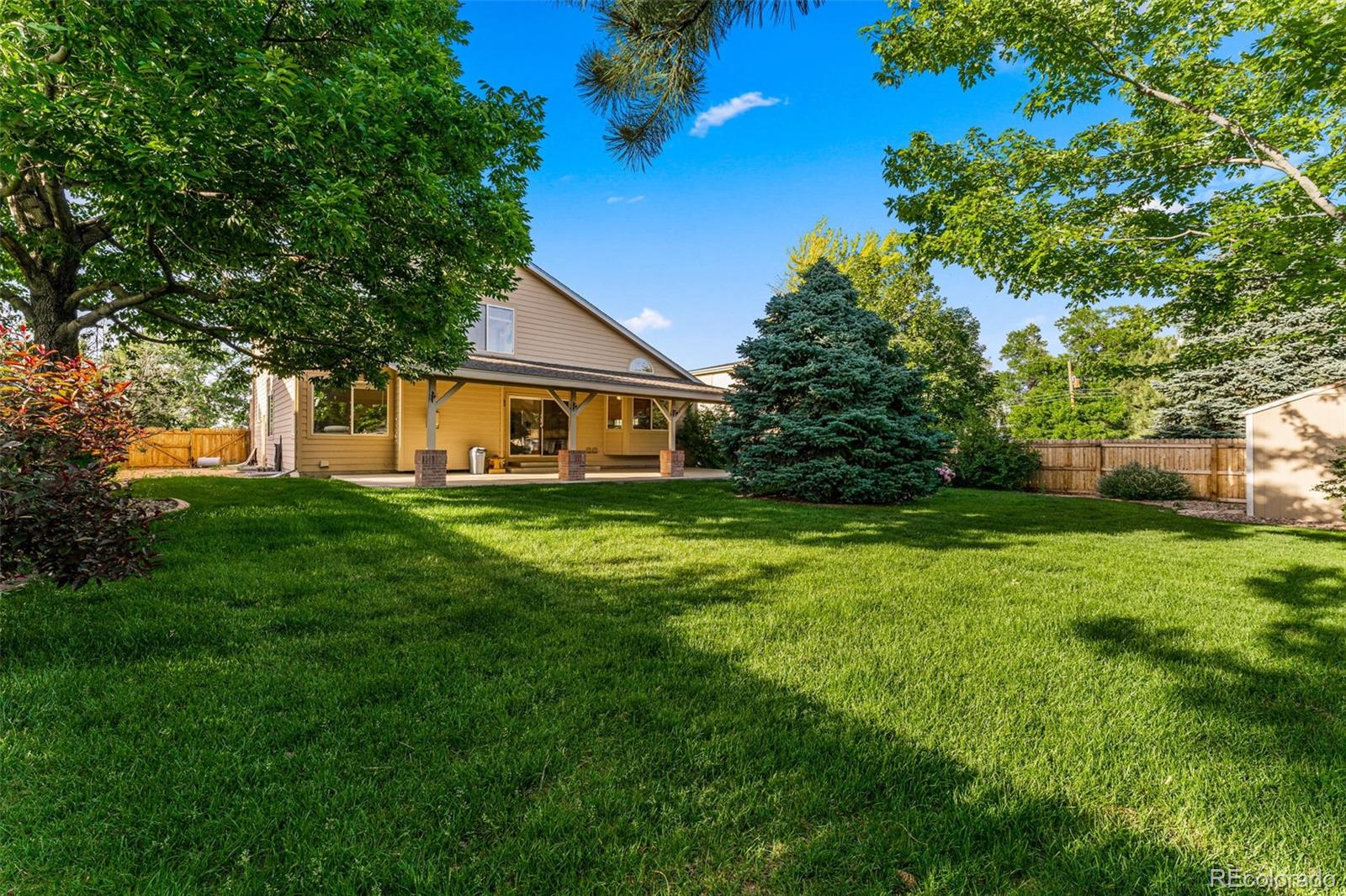 276 East Fair Lane Centennial, CO 80121 - Photo 36 of 38 a front view of a house with a yard