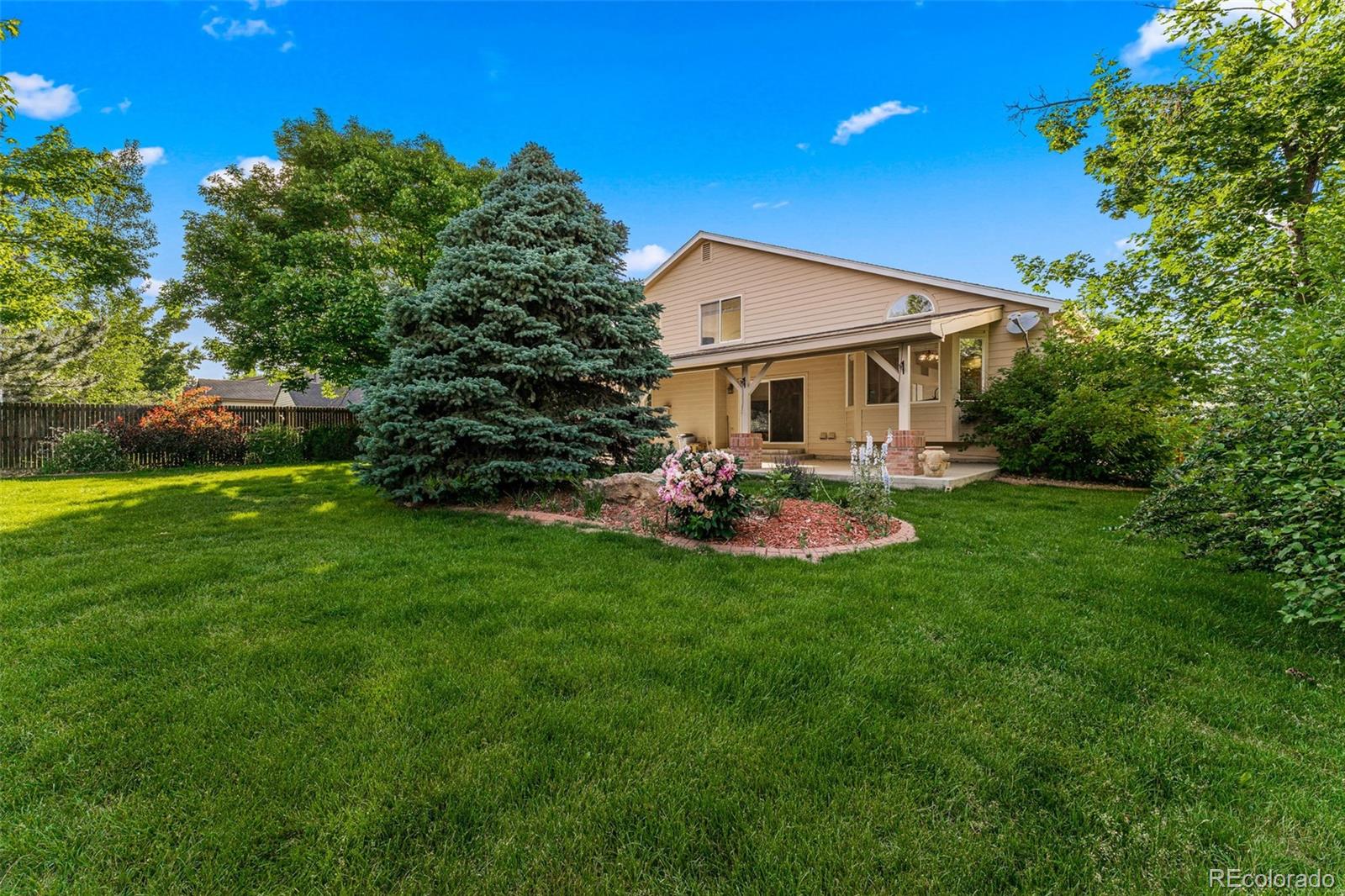 276 East Fair Lane Centennial, CO 80121 - Photo 37 of 38 a view of a patio with table and chairs and potted plants with large tree
