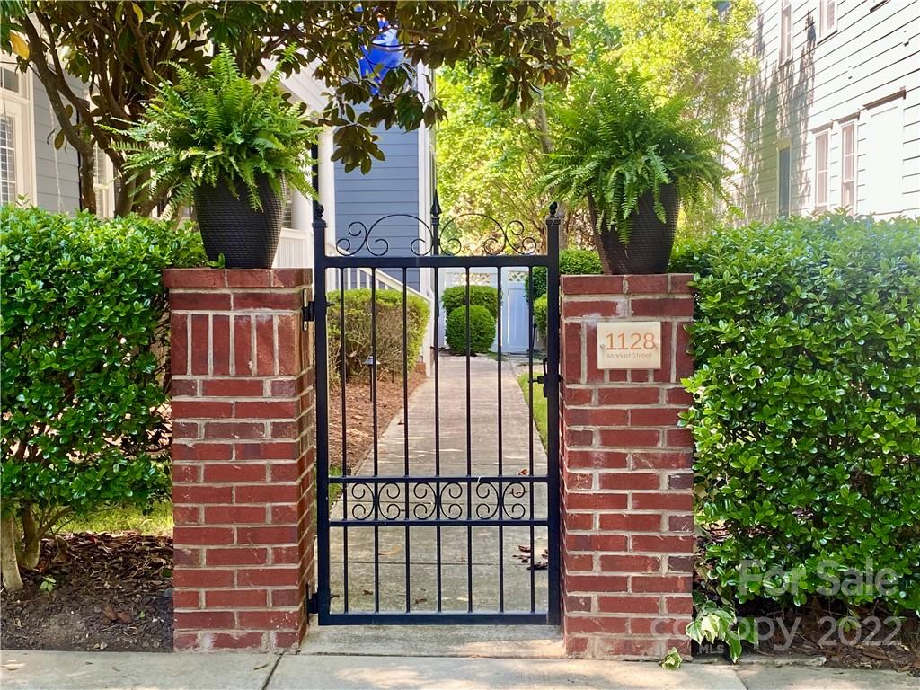 1128 Market Street Fort Mill, SC 29708 - Photo 3 of 46 a view of a brick house with a flower garden