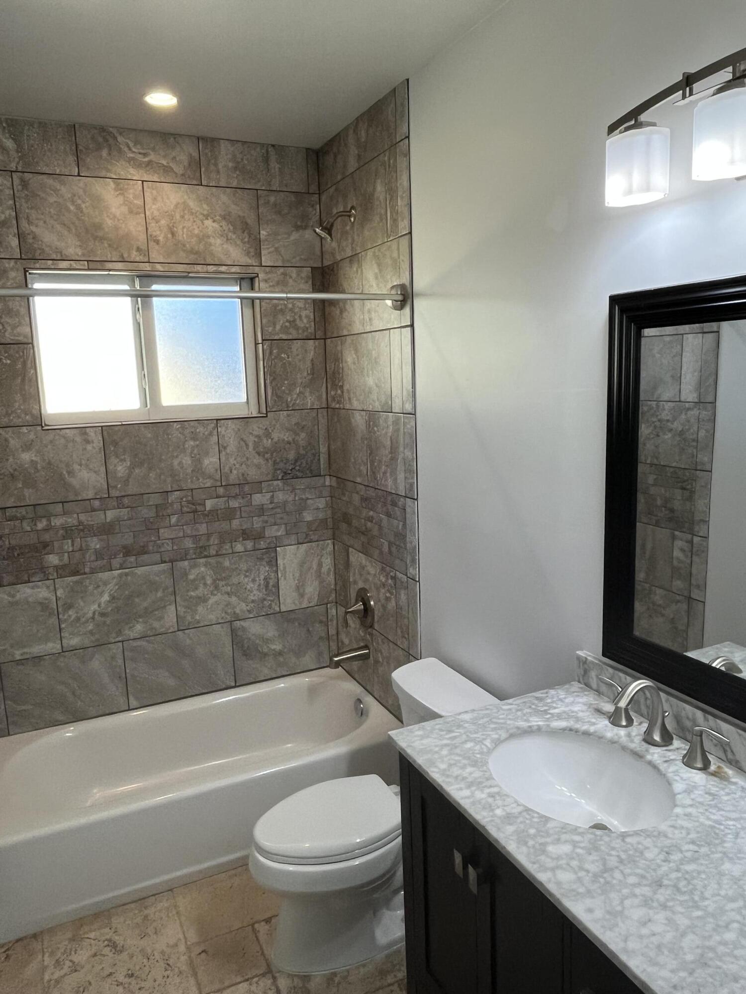 639 Cabrera Street Key Largo, FL 33037 - Photo 21 of 24 a bathroom with a granite countertop sink toilet and shower
