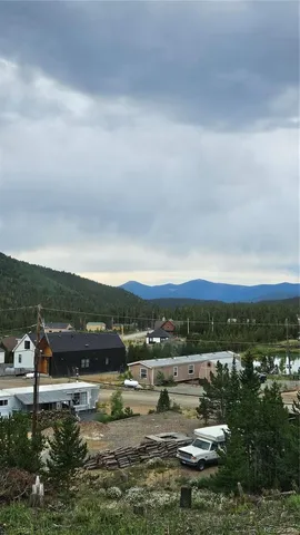 a view of a lake with houses in back