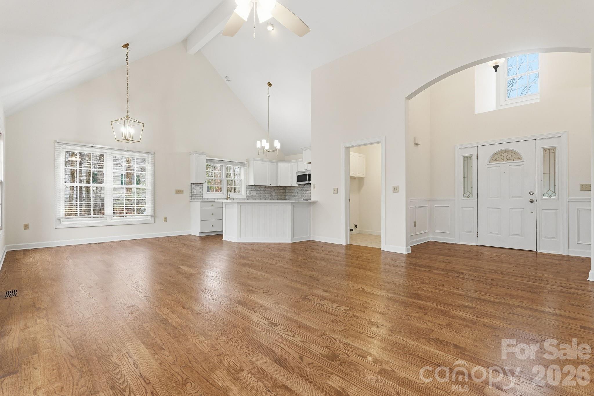 157 Byers Road Troutman, NC 28166 - Photo 12 of 32 a view of empty room with wooden floor and kitchen view