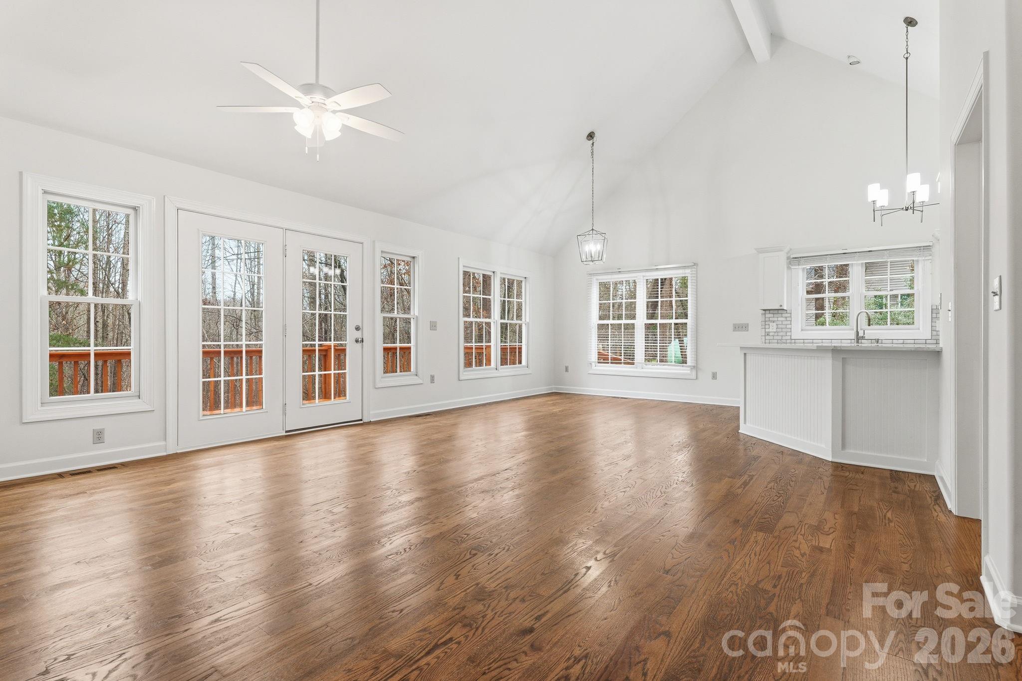 157 Byers Road Troutman, NC 28166 - Photo 13 of 32 a view of an empty room with wooden floor and a window