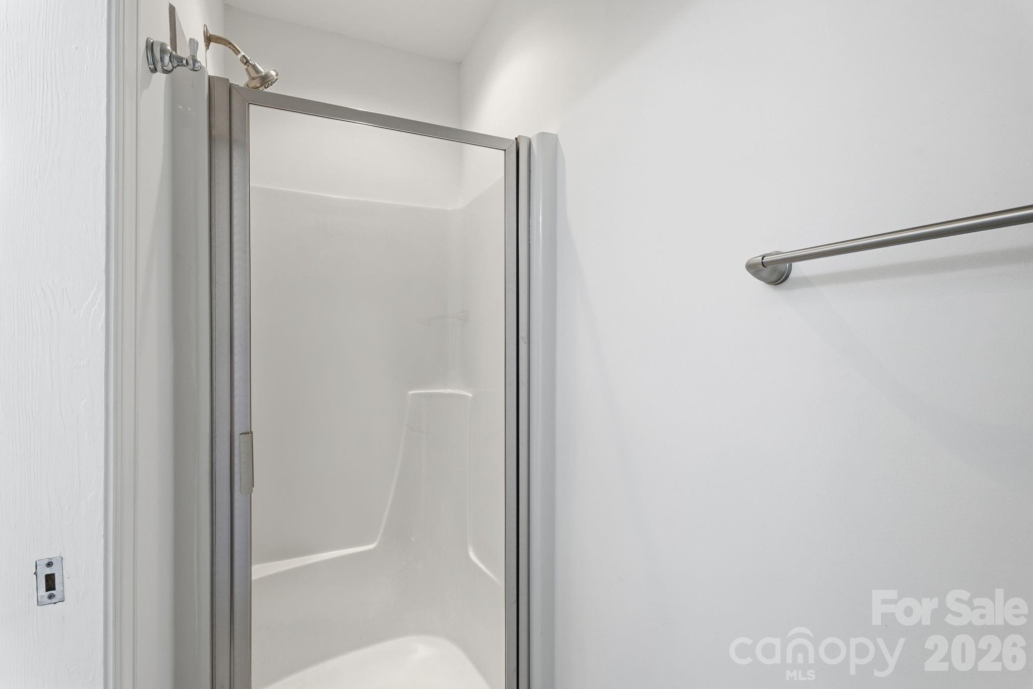 157 Byers Road Troutman, NC 28166 - Photo 17 of 32 a bathroom with a glass shower door