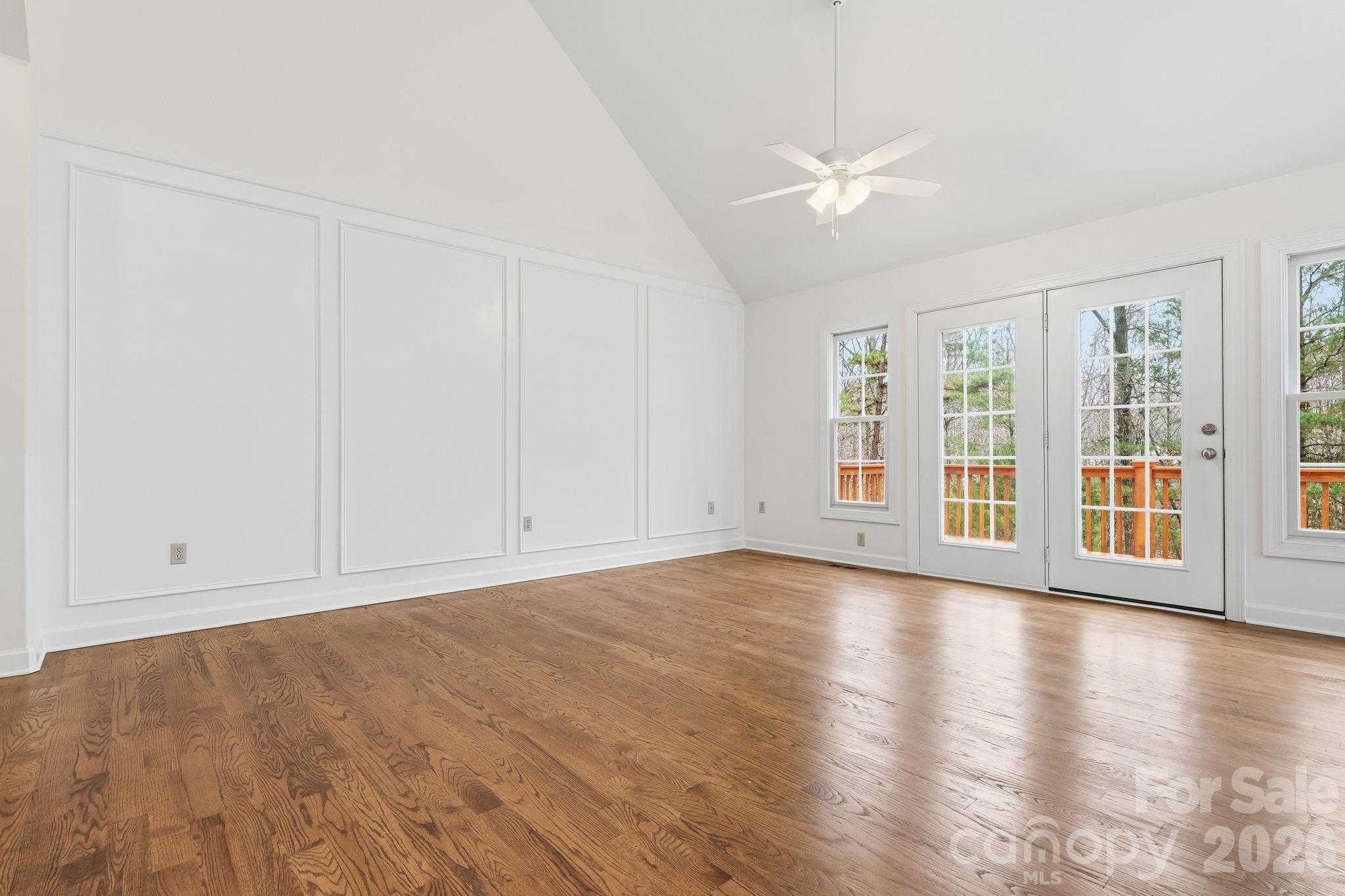 157 Byers Road Troutman, NC 28166 - Photo 5 of 32 a view of an empty room with wooden floor and a window