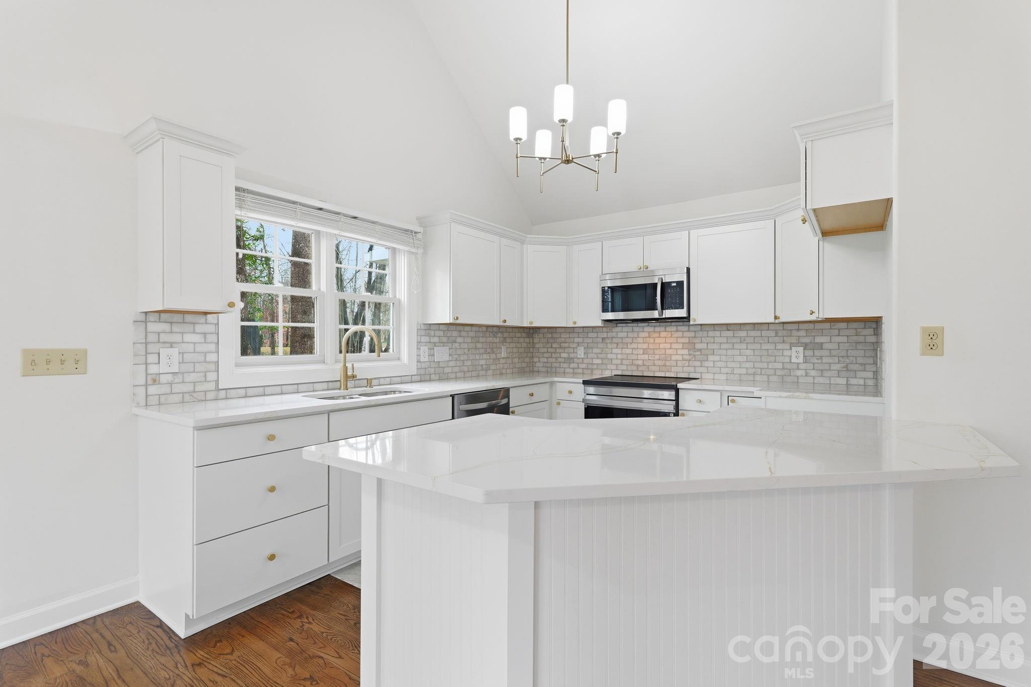 157 Byers Road Troutman, NC 28166 - Photo 9 of 32 a kitchen with granite countertop white cabinets and stainless steel appliances