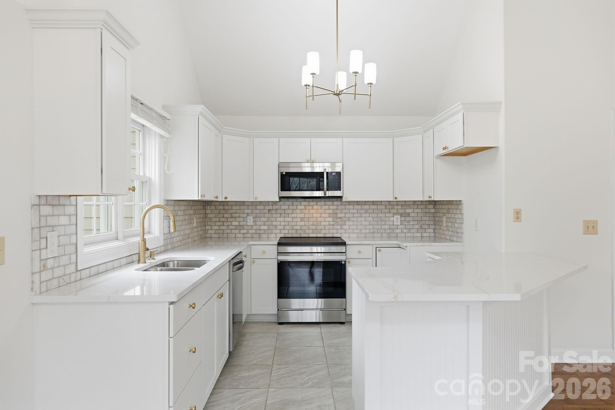 157 Byers Road Troutman, NC 28166 - Photo 10 of 32 a kitchen with stainless steel appliances granite countertop a sink stove and microwave