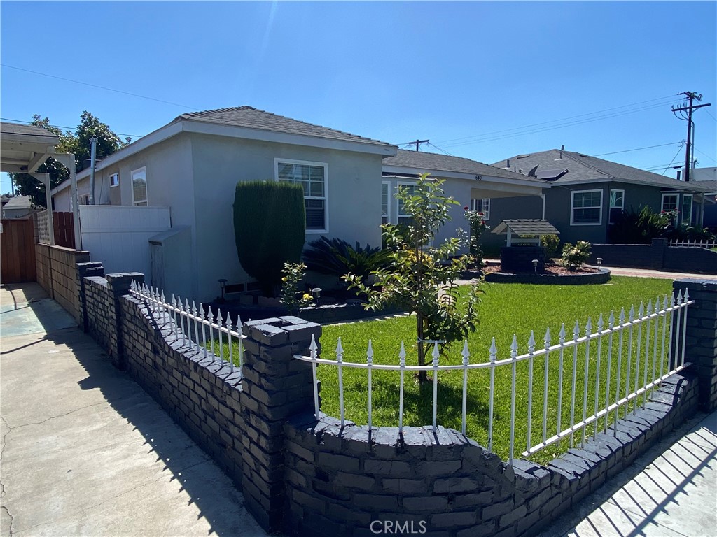 640 East Harding Street Long Beach, CA 90805 - Photo 2 of 3 a view of a house with wooden fence and a porch