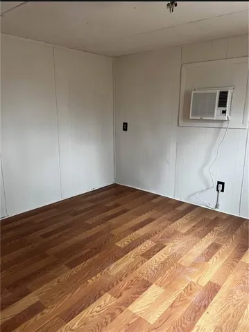 a view of a livingroom with wooden floor and a sink
