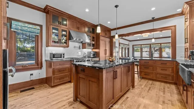 a kitchen with stainless steel appliances granite countertop a stove and cabinets