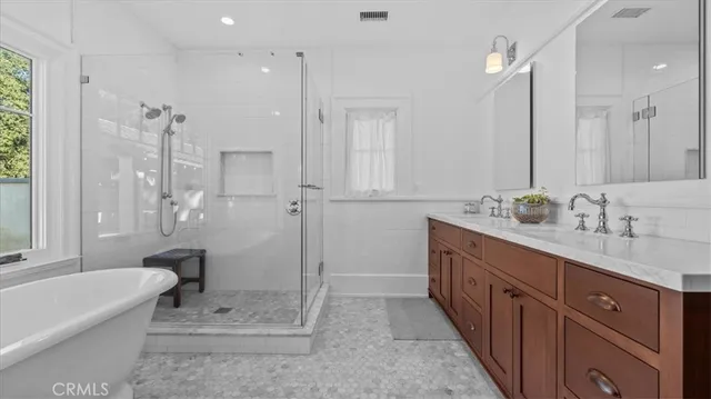 a bathroom with a granite countertop sink mirror and a bathtub