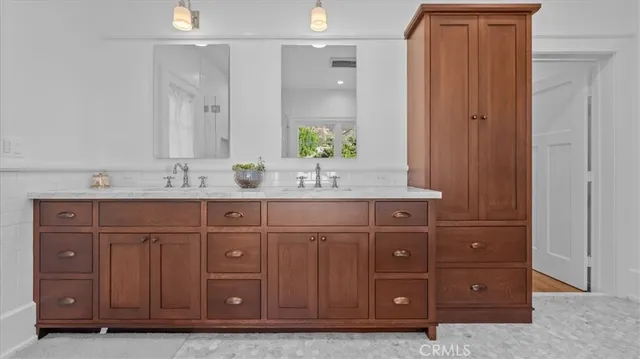 a bathroom with a sink vanity and mirror