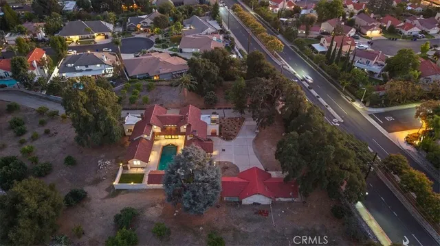 an aerial view of a house with a yard swimming pool and outdoor seating