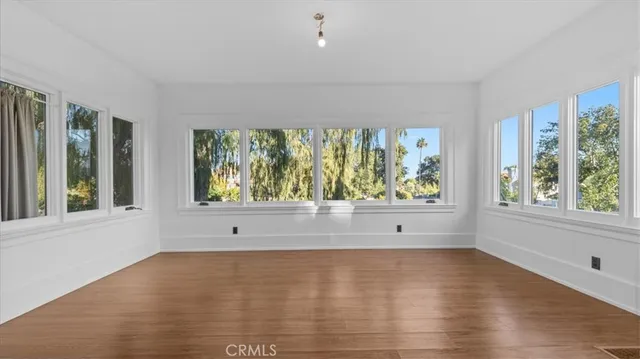 a view of room with window and wooden floor