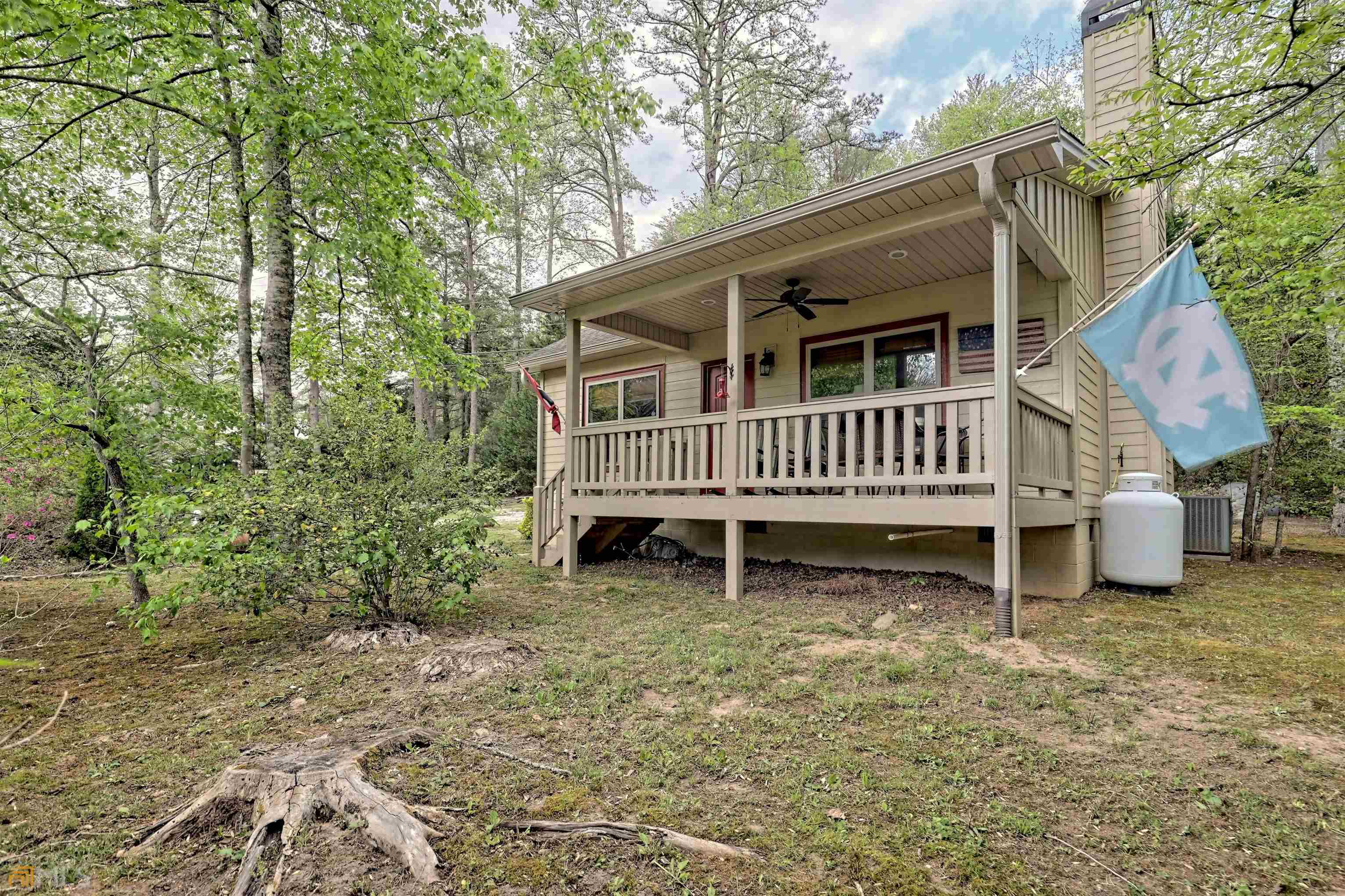 a view of a house with a yard and deck