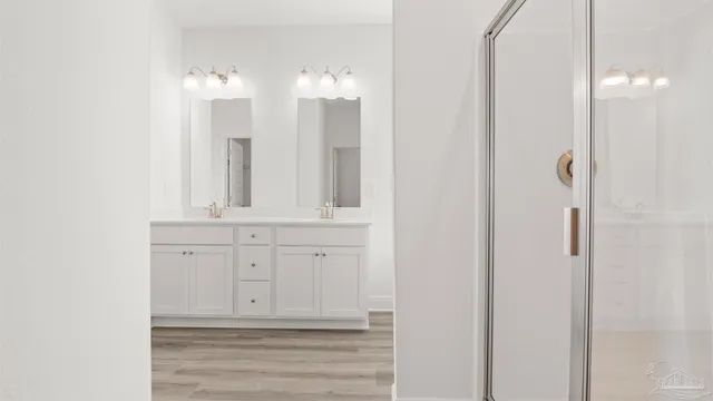 a bathroom with a double vanity sink and mirror