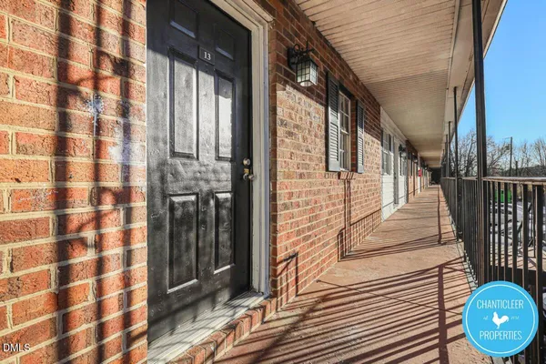 a view of a balcony with wooden floor and iron stairs