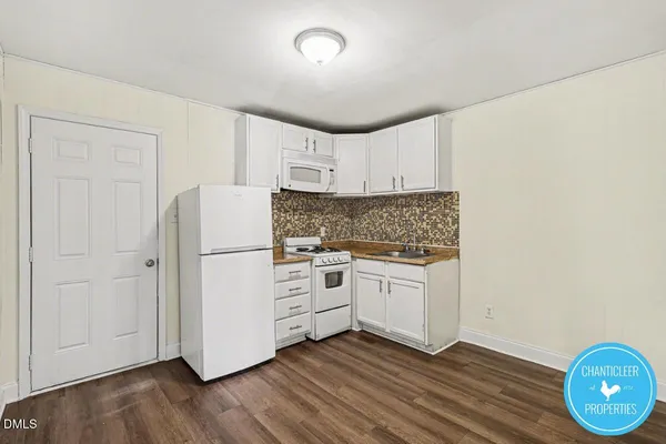 a view of a storage and utility room with wooden floor