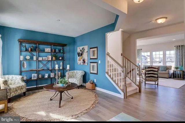 a living room with furniture and a book shelf