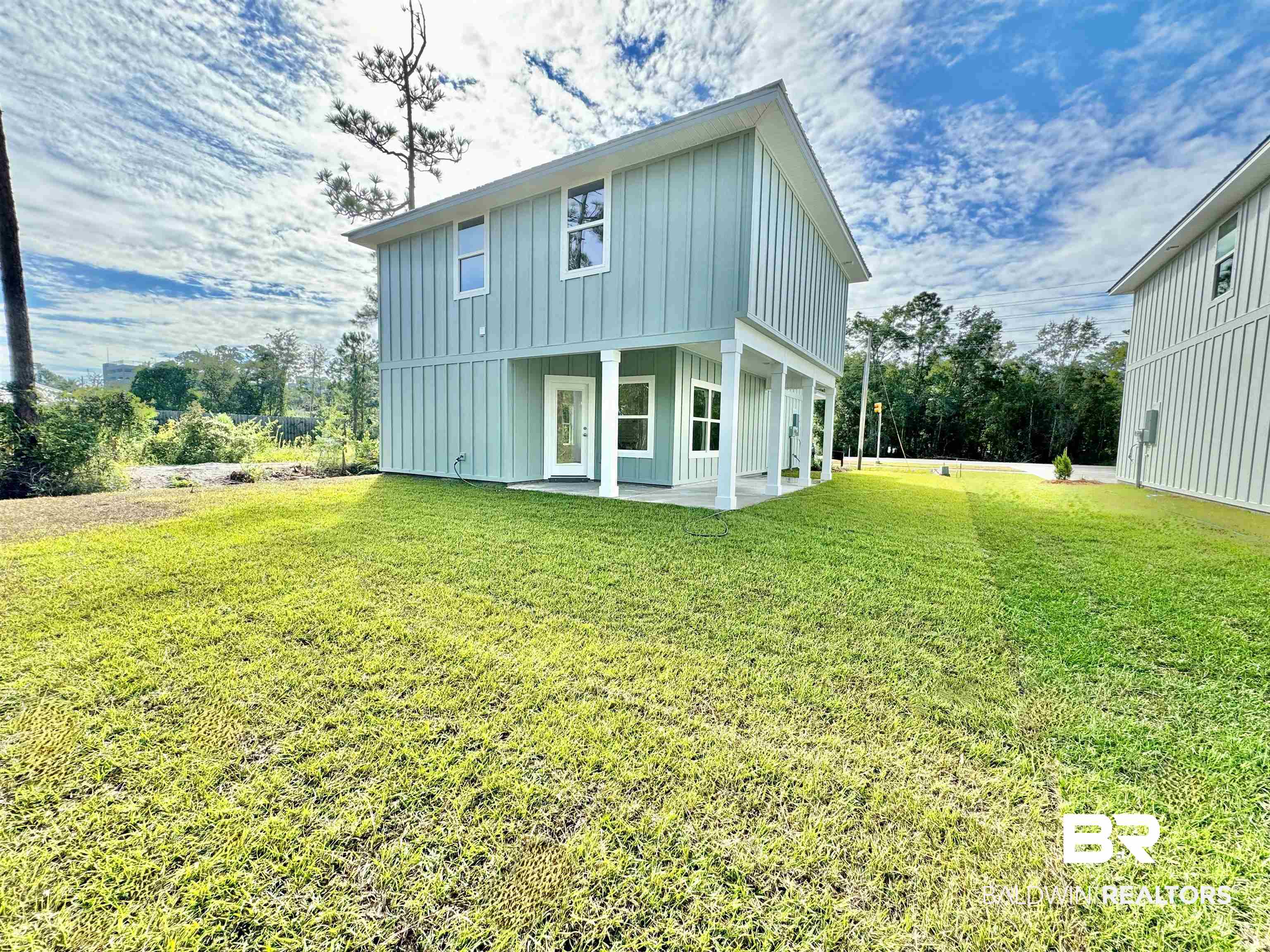27491 Canal Road Orange Beach, AL 36561 - Photo 5 of 20 Back of property with a lawn