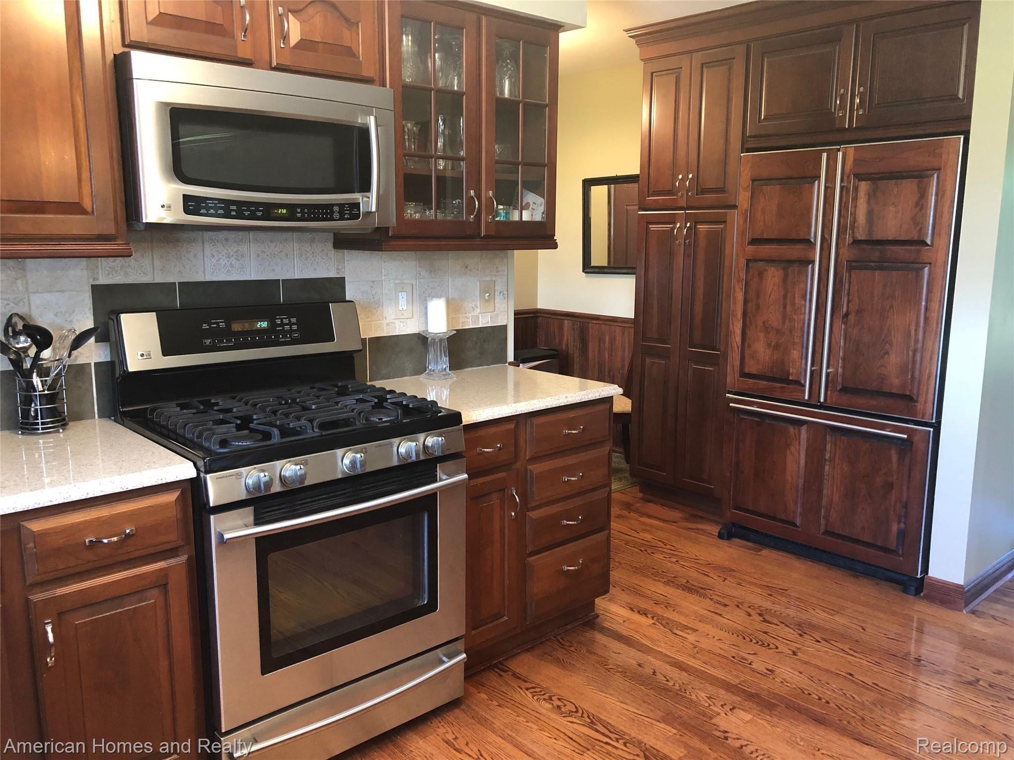 3073 Bolton Road Lapeer, MI 48446 - Photo 18 of 42 Cherry wood cabinets and refrig