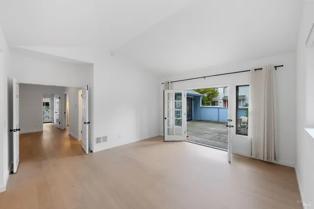 a view of a big room with wooden floor and a livingroom