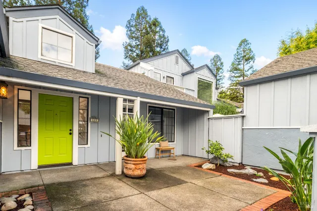 a view of house with outdoor space and potted plants