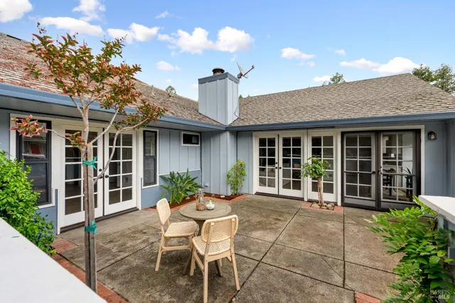 a view of a house with backyard sitting area and porch