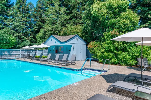 a house with swimming pool in front of it