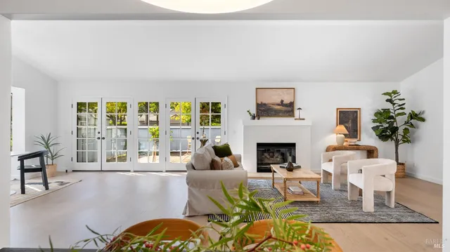 a living room with furniture fireplace and a large window