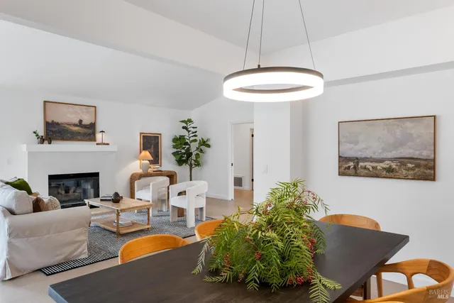 a living room with furniture a chandelier and a fireplace