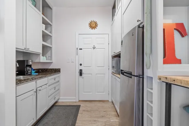 a kitchen with stainless steel appliances granite countertop a refrigerator and a stove