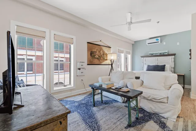 a living room with furniture a rug and a window