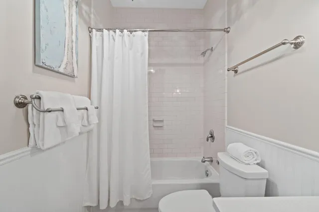 a bathroom with a shower a toilet and a shower