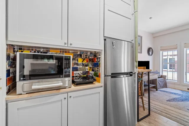 a white refrigerator freezer and a stove sitting inside of a kitchen