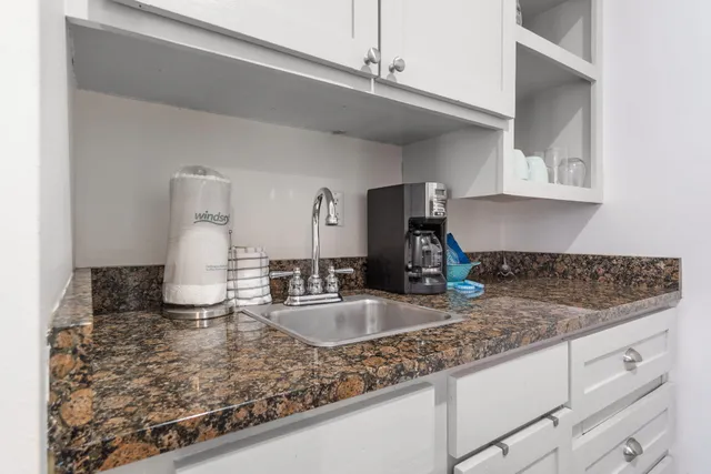 a kitchen with sink and cabinets
